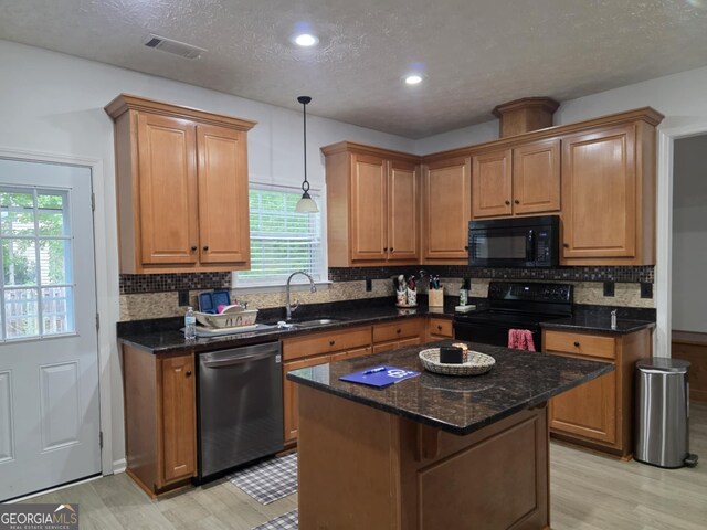 10315 Whisper Glen Dr, Midland, GA 31820 - kitchen with black appliances, a sink, light wood-style floors, plenty of natural light, and a textured ceiling