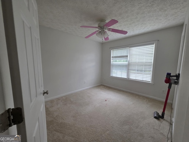 10315 Whisper Glen Dr, Midland, GA 31820 - spare room with light carpet, baseboards, a ceiling fan, and a textured ceiling