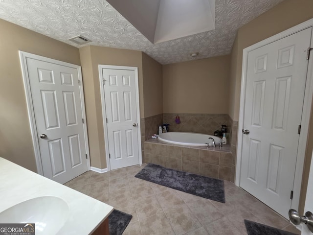 10315 Whisper Glen Dr, Midland, GA 31820 - full bathroom featuring vanity, a bath, and tile patterned floors