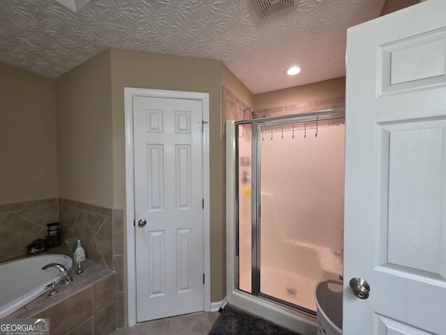 10315 Whisper Glen Dr, Midland, GA 31820 - full bath featuring a shower stall, a bath, recessed lighting, and tile patterned floors