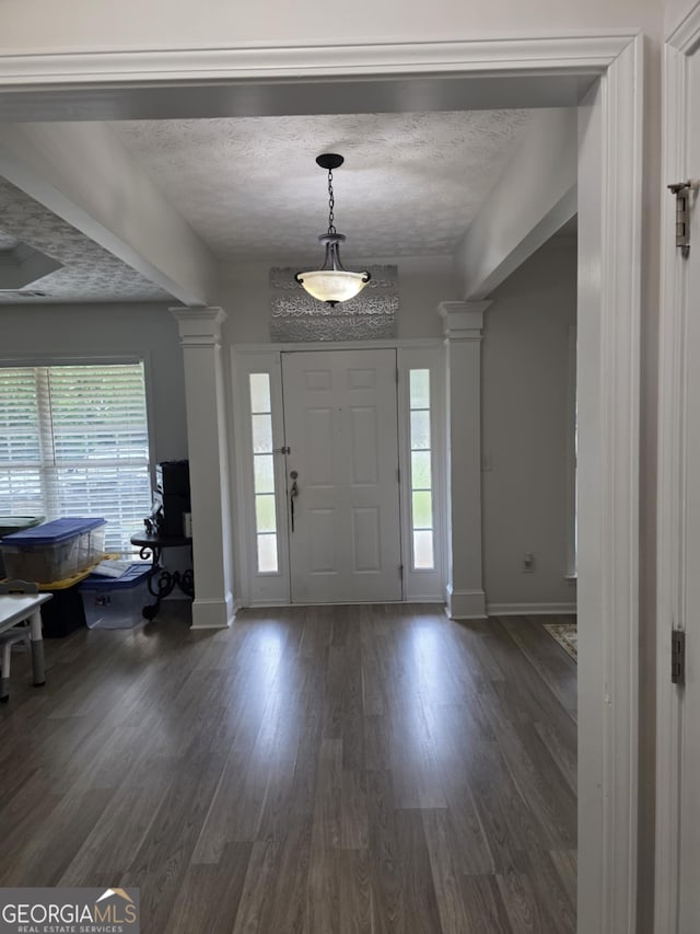 10315 Whisper Glen Dr, Midland, GA 31820 - foyer with ornate columns, baseboards, plenty of natural light, and dark wood-style floors