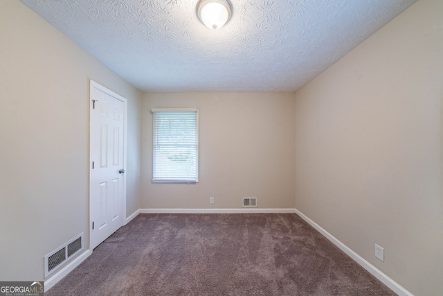 4457 Lincoln Jones Rd, Ellenwood, GA 30294 - carpeted empty room featuring a textured ceiling and baseboards