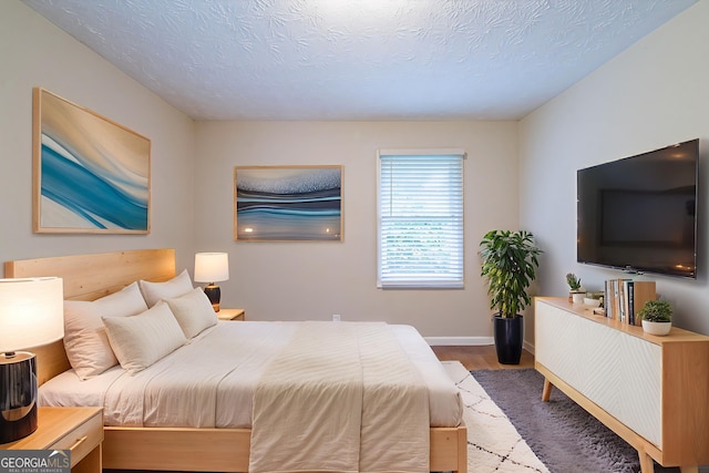4457 Lincoln Jones Rd, Ellenwood, GA 30294 - bedroom with wood finished floors, baseboards, and a textured ceiling