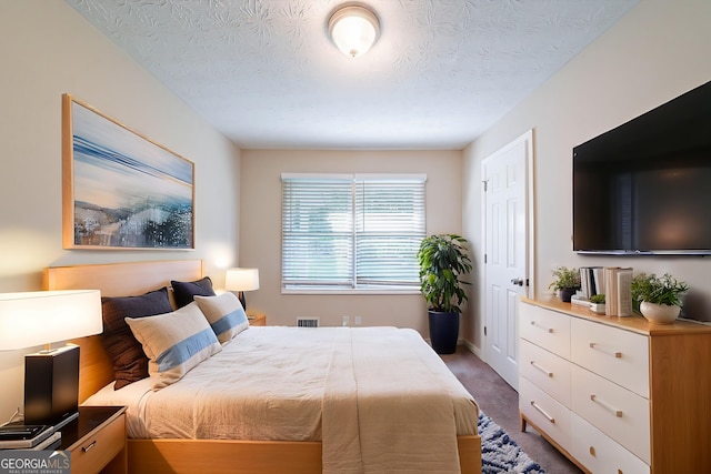 4457 Lincoln Jones Rd, Ellenwood, GA 30294 - bedroom with carpet flooring and a textured ceiling