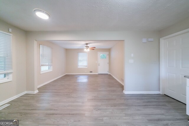 4457 Lincoln Jones Rd, Ellenwood, GA 30294 - unfurnished room featuring ceiling fan, light wood finished floors, baseboards, and a textured ceiling