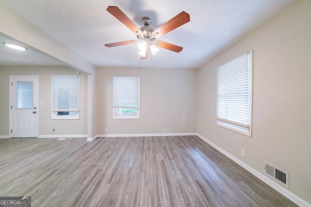 4457 Lincoln Jones Rd, Ellenwood, GA 30294 - spare room featuring wood finished floors, healthy amount of natural light, baseboards, and a ceiling fan