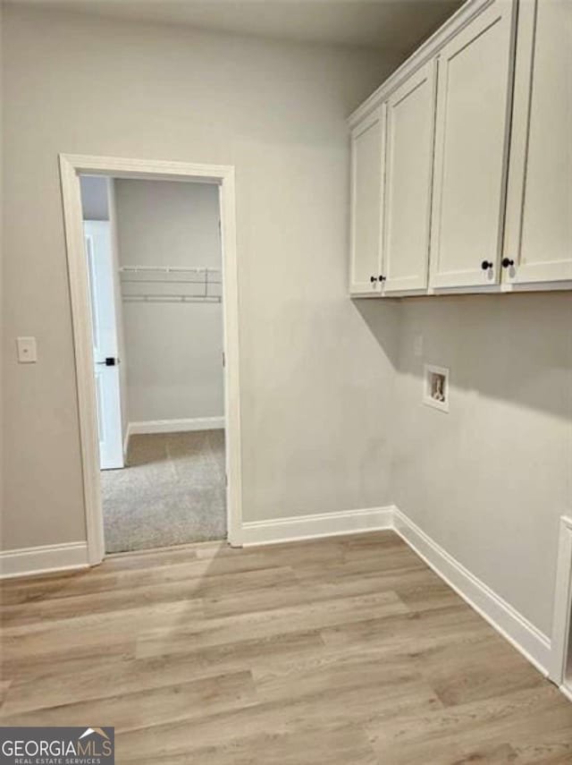 1695 Crumbley Rd Unit 3, Mcdonough, GA 30252 - laundry area with baseboards, cabinet space, washer hookup, and light wood-type flooring