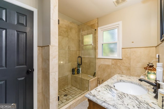 271 Double Gate Ct, Sugar Hill, GA 30518 - bathroom with a stall shower, tile walls, and vanity