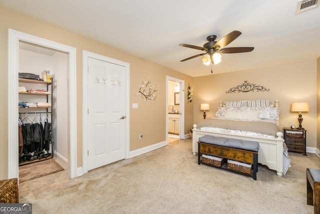 271 Double Gate Ct, Sugar Hill, GA 30518 - carpeted bedroom with connected bathroom, ceiling fan, a closet, and a walk in closet