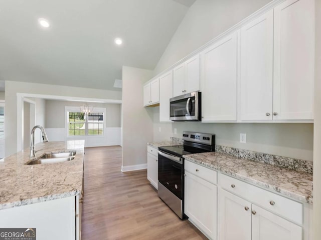 204 Rachel Ln, Hartwell, GA 30643 - kitchen with appliances with stainless steel finishes, a sink, lofted ceiling, white cabinetry, and recessed lighting