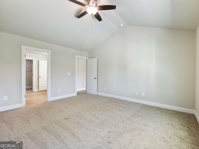204 Rachel Ln, Hartwell, GA 30643 - unfurnished bedroom featuring light colored carpet, lofted ceiling, baseboards, ceiling fan, and a spacious closet