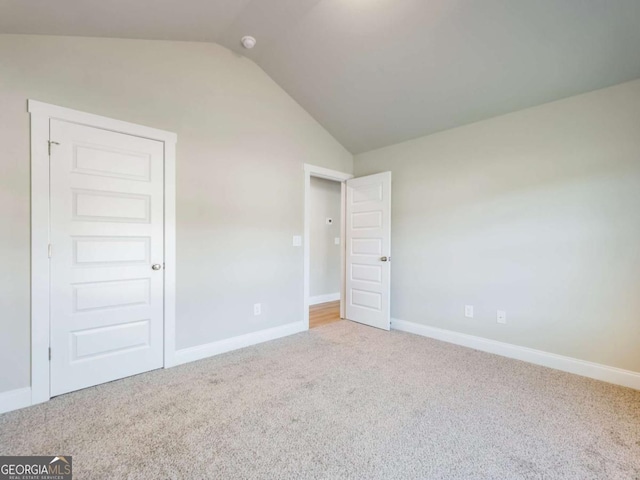 204 Rachel Ln, Hartwell, GA 30643 - unfurnished bedroom featuring lofted ceiling, carpet flooring, and baseboards