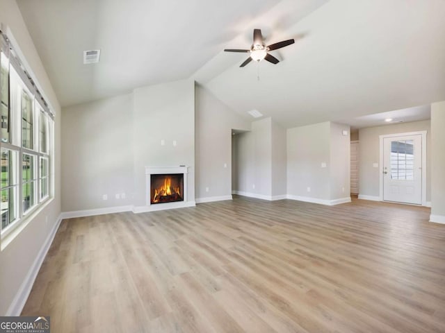 204 Rachel Ln, Hartwell, GA 30643 - unfurnished living room featuring light wood finished floors, a lit fireplace, a ceiling fan, baseboards, and vaulted ceiling