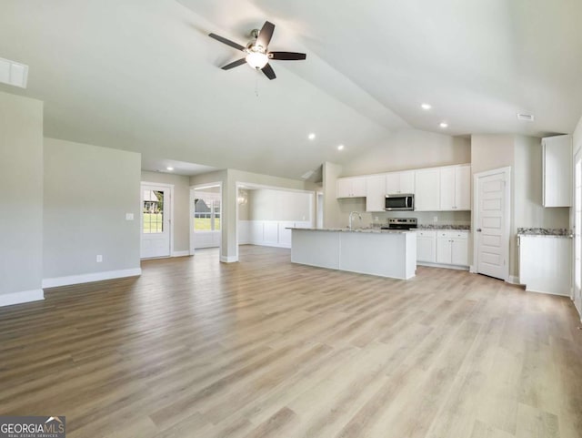 204 Rachel Ln, Hartwell, GA 30643 - unfurnished living room featuring a ceiling fan, baseboards, high vaulted ceiling, a sink, and light wood-style floors