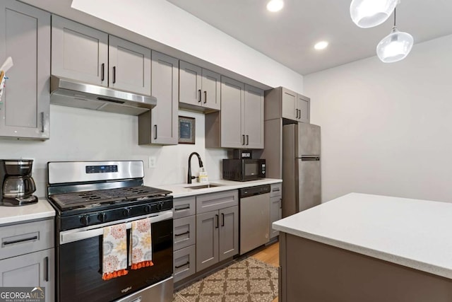 4110 Gentle Breeze Way, Braselton, GA 30517 - kitchen with stainless steel appliances, a sink, under cabinet range hood, gray cabinets, and recessed lighting