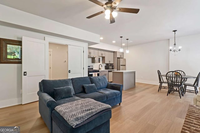 4110 Gentle Breeze Way, Braselton, GA 30517 - living room with baseboards, a ceiling fan, a chandelier, light wood-style flooring, and recessed lighting