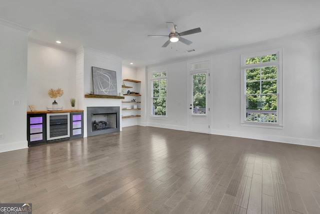 113 Quinn Way, Milton, GA 30004 - unfurnished living room with beverage cooler, ceiling fan, wood finished floors, ornamental molding, and recessed lighting