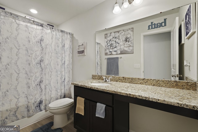 33 Easy St, Guyton, GA 31312 - full bathroom featuring toilet, vanity, wood finished floors, and shower / bath combination with curtain