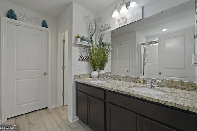 33 Easy St, Guyton, GA 31312 - full bath featuring double vanity, an enclosed shower, and wood finished floors