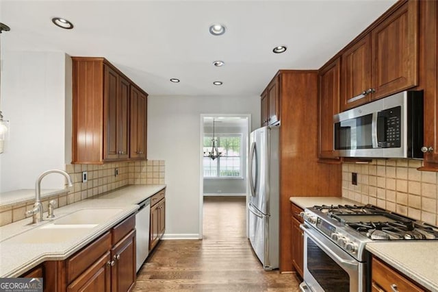14 Augusta Way, Hiram, GA 30141 - kitchen featuring stainless steel appliances, wood finished floors, recessed lighting, decorative backsplash, and a sink