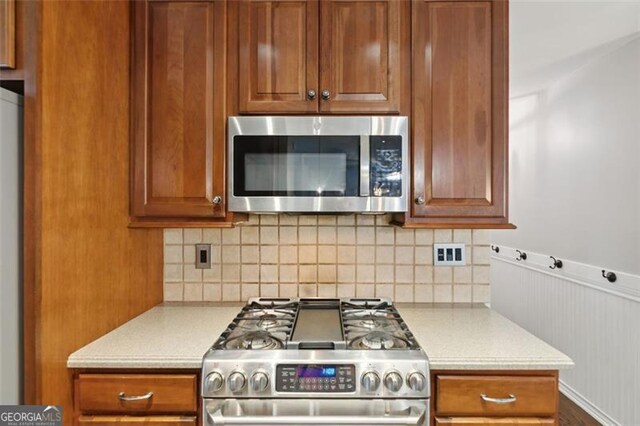 14 Augusta Way, Hiram, GA 30141 - kitchen with appliances with stainless steel finishes, light countertops, decorative backsplash, and brown cabinets