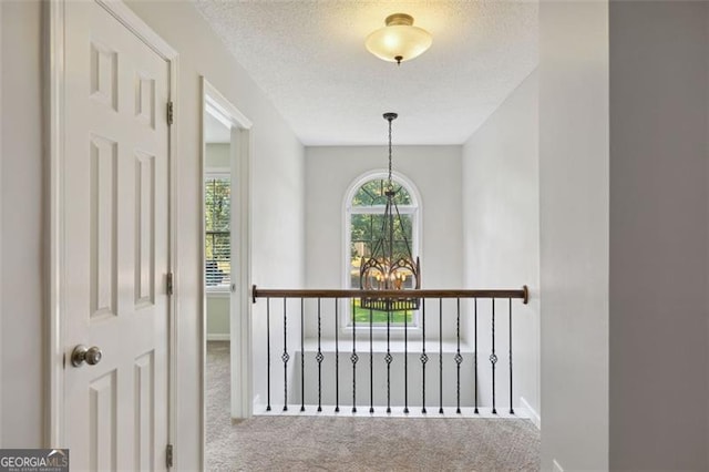 14 Augusta Way, Hiram, GA 30141 - hallway featuring carpet floors, a chandelier, baseboards, and a textured ceiling