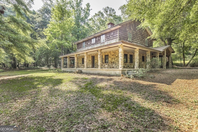 3222 US Highway 80 W, Dublin, GA 31021 - view of front of property with a porch, a chimney, and stone siding