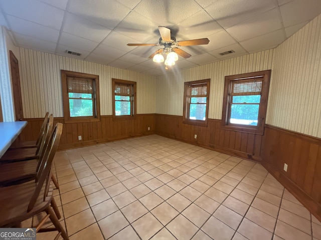 3222 US Highway 80 W, Dublin, GA 31021 - unfurnished dining area with healthy amount of natural light, ceiling fan, a wainscoted wall, a paneled ceiling, and wooden walls