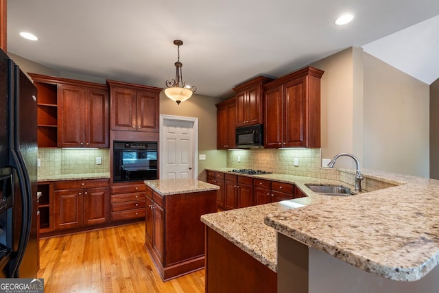 203 Crescent Moon Way, Canton, GA 30114 - kitchen featuring black appliances, a sink, a peninsula, light wood-style flooring, and hanging light fixtures