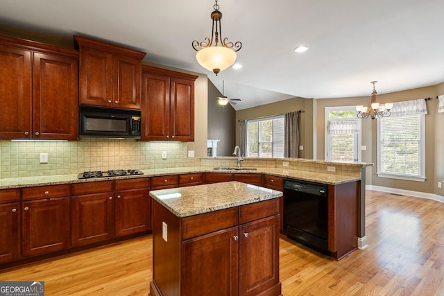 203 Crescent Moon Way, Canton, GA 30114 - kitchen featuring black appliances, a sink, light wood-type flooring, a peninsula, and vaulted ceiling