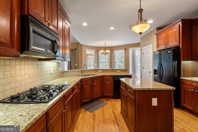 203 Crescent Moon Way, Canton, GA 30114 - kitchen featuring black appliances, a sink, light wood-type flooring, a chandelier, and pendant lighting