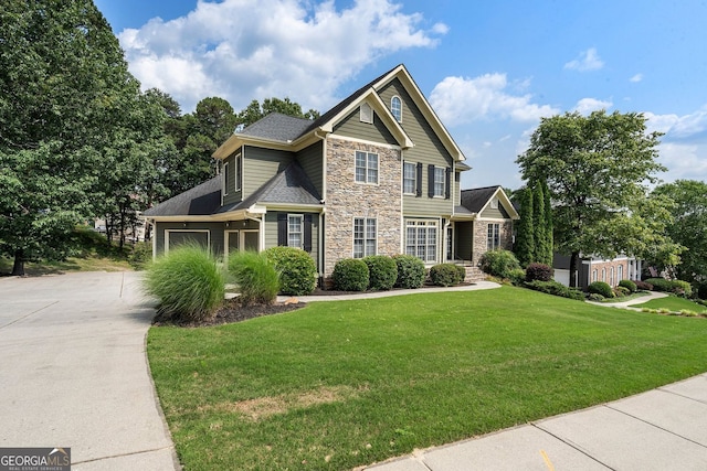 203 Crescent Moon Way, Canton, GA 30114 - view of front facade with stone siding, driveway, a front yard, and an attached garage