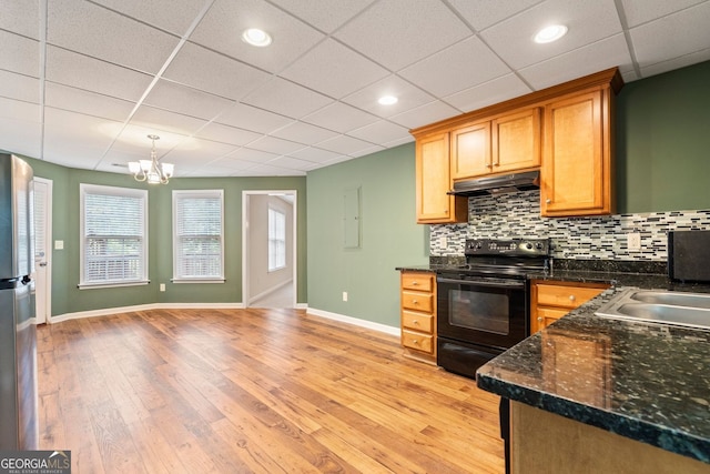 203 Crescent Moon Way, Canton, GA 30114 - kitchen with black range with electric cooktop, under cabinet range hood, baseboards, light wood-style flooring, and a chandelier