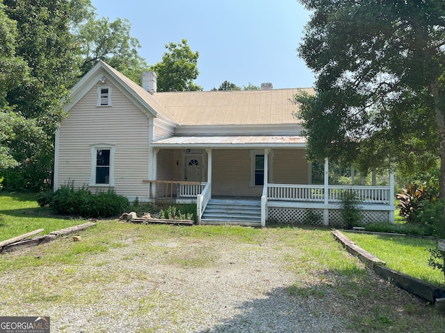 459 Railroad Ave, Flovilla, GA 30216 - view of front of house featuring a chimney, covered porch, metal roof, and a front yard