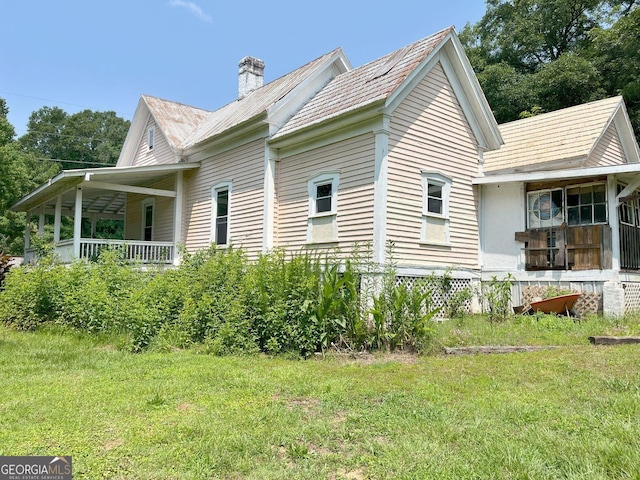 459 Railroad Ave, Flovilla, GA 30216 - view of home's exterior with a chimney, a yard, and a porch