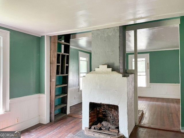 459 Railroad Ave, Flovilla, GA 30216 - unfurnished living room featuring a wainscoted wall, hardwood / wood-style floors, ornamental molding, plenty of natural light, and a fireplace