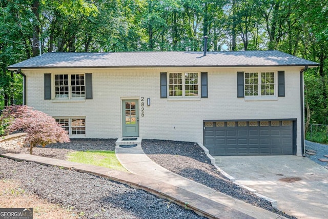 2825 Shea Way SW, Marietta, GA 30060 - raised ranch featuring an attached garage, driveway, brick siding, and roof with shingles