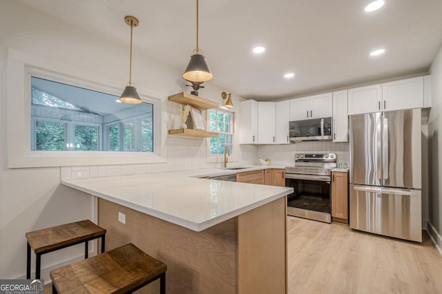 2825 Shea Way SW, Marietta, GA 30060 - kitchen featuring stainless steel appliances, a peninsula, a breakfast bar area, tasteful backsplash, and open shelves