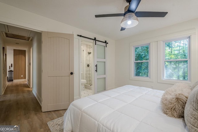 2825 Shea Way SW, Marietta, GA 30060 - bedroom with a barn door, wood finished floors, ensuite bathroom, attic access, and ceiling fan