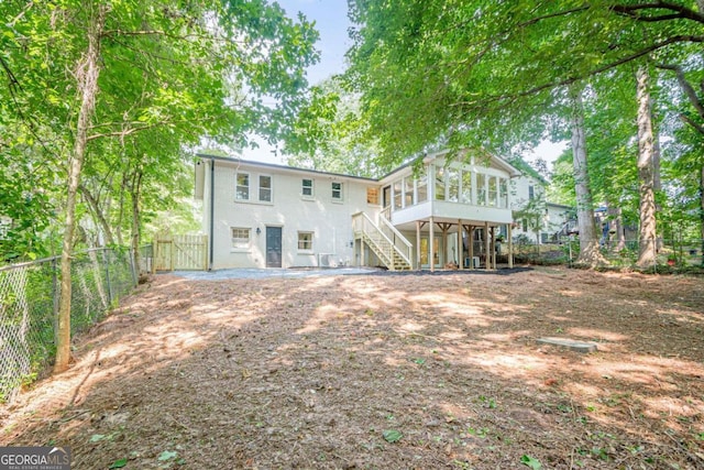 2825 Shea Way SW, Marietta, GA 30060 - rear view of house featuring a sunroom, stairway, a fenced backyard, and a gate