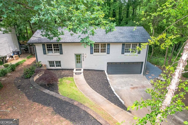 2825 Shea Way SW, Marietta, GA 30060 - bi-level home featuring a garage, brick siding, concrete driveway, and a shingled roof