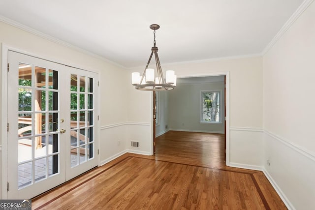 5240 Arrie Way, Atlanta, GA 30360 - unfurnished dining area featuring french doors, a chandelier, healthy amount of natural light, ornamental molding, and light wood-style flooring