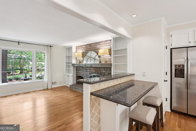 5240 Arrie Way, Atlanta, GA 30360 - kitchen with stainless steel refrigerator with ice dispenser, wood finished floors, white cabinets, a kitchen breakfast bar, and dark stone countertops