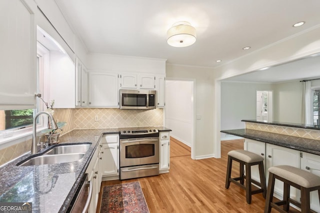 5240 Arrie Way, Atlanta, GA 30360 - kitchen with stainless steel appliances, a sink, white cabinetry, light wood-style floors, and recessed lighting