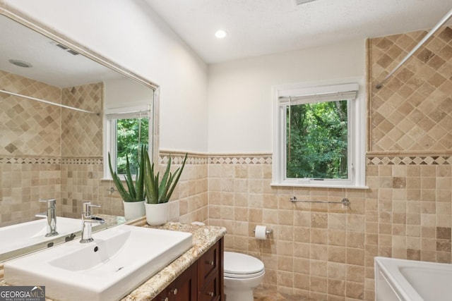5240 Arrie Way, Atlanta, GA 30360 - bathroom featuring tile walls, healthy amount of natural light, vanity, a bathtub, and toilet