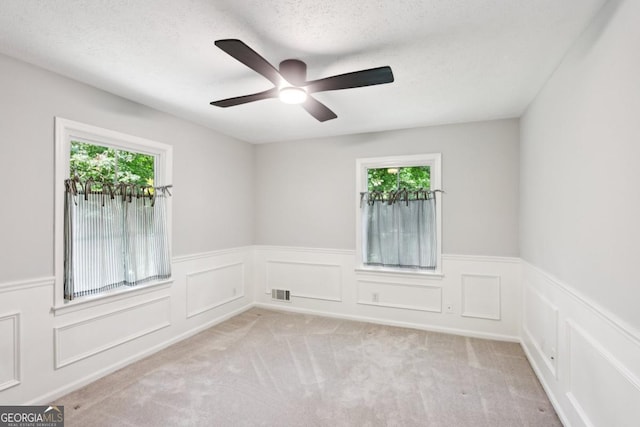 5240 Arrie Way, Atlanta, GA 30360 - empty room with a wainscoted wall, a ceiling fan, carpet floors, and a textured ceiling