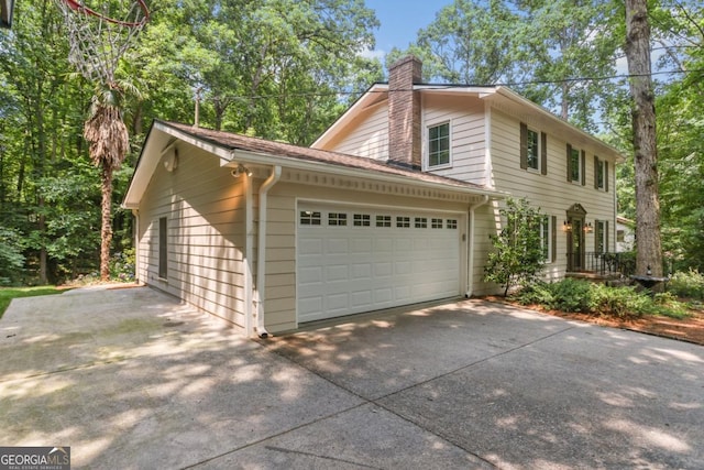 5240 Arrie Way, Atlanta, GA 30360 - view of property exterior with a chimney, an attached garage, and concrete driveway