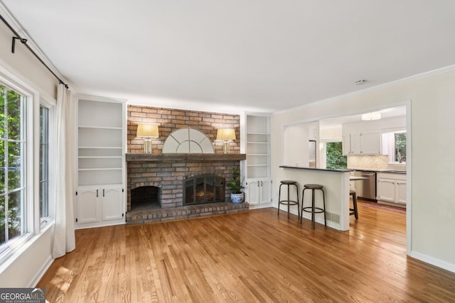5240 Arrie Way, Atlanta, GA 30360 - living area featuring light wood-style flooring, a fireplace, built in features, and baseboards