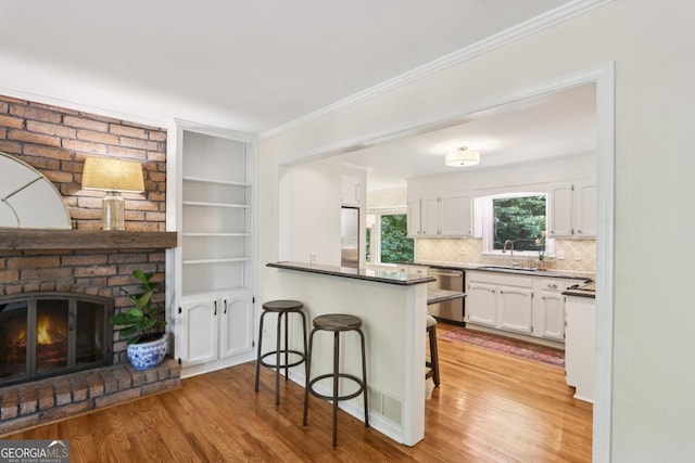 5240 Arrie Way, Atlanta, GA 30360 - kitchen featuring light wood-style floors, white cabinets, a breakfast bar, stainless steel appliances, and a sink