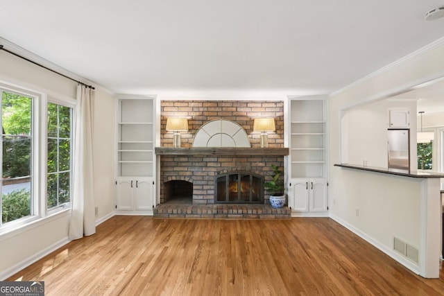 5240 Arrie Way, Atlanta, GA 30360 - unfurnished living room with baseboards, wood finished floors, built in features, a fireplace, and crown molding